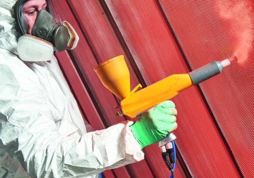 Professional powder coating application showing vibrant blue automotive wheel finish